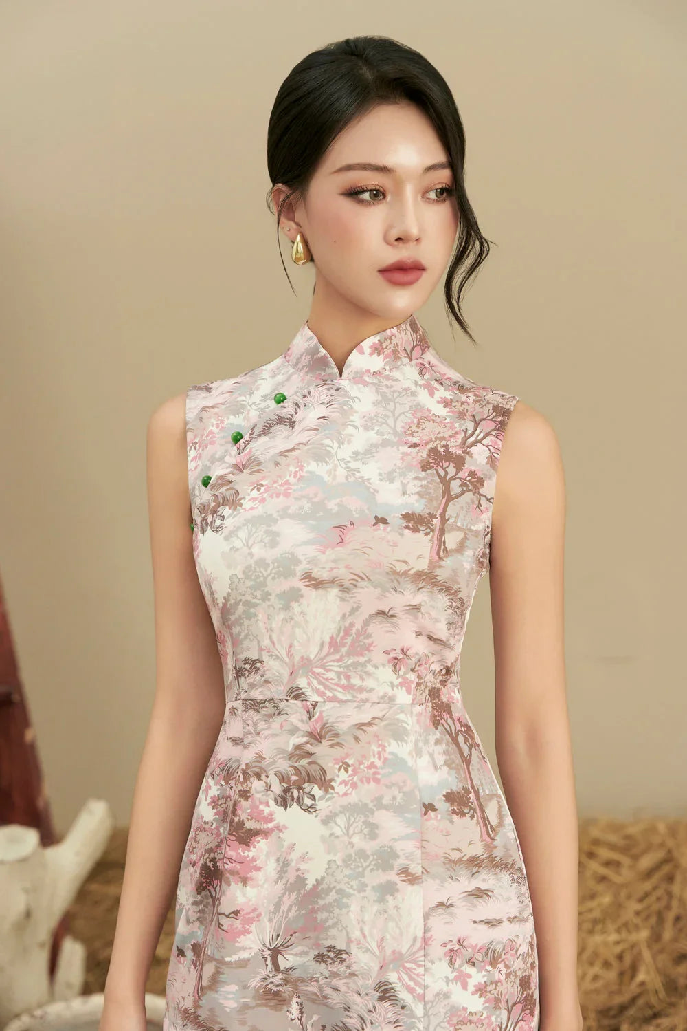 Woman wearing sleeveless modern cheongsam with pastel floral landscape print, elegant look