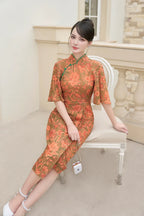 Woman in elegant modern floral cheongsam with half sleeves, sitting on a white chair outdoors