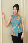 Woman wearing modern sleeveless floral cheongsam with blue, orange, and pink patterns
