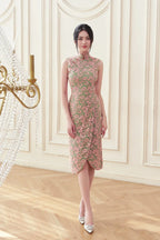Woman in elegant pink floral lace cheongsam dress with mandarin collar, standing indoors